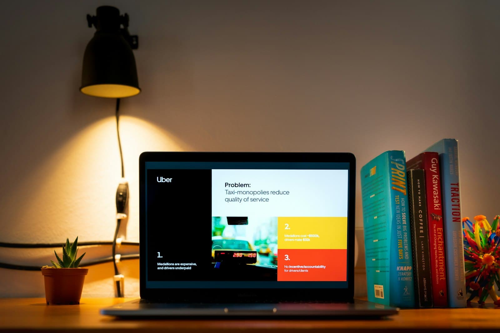 Arbeidsflate med skjerm, notater og produktpresentasjon i et fokusert kontormiljo